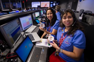 2 female NASA employees posing at their workstations for the Mars Curiosity program.