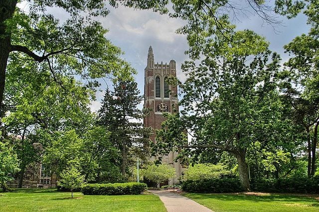 Beaumont Tower at Michigan State University seen behind the trees.
