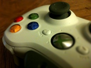 Close-up shot of a white Xbox game controller with red, green, blue and yellow buttons.