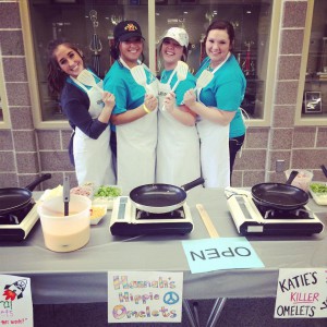 Alpha Omicron Pi sisters holding a spatula ready to cook omelette breakfast.