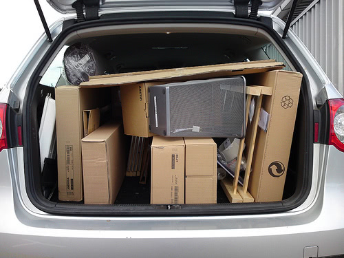 A van trunk filled to the brim with college moving boxes.