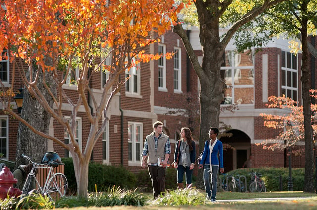 3 students walking through University of Central Arkansas campus.