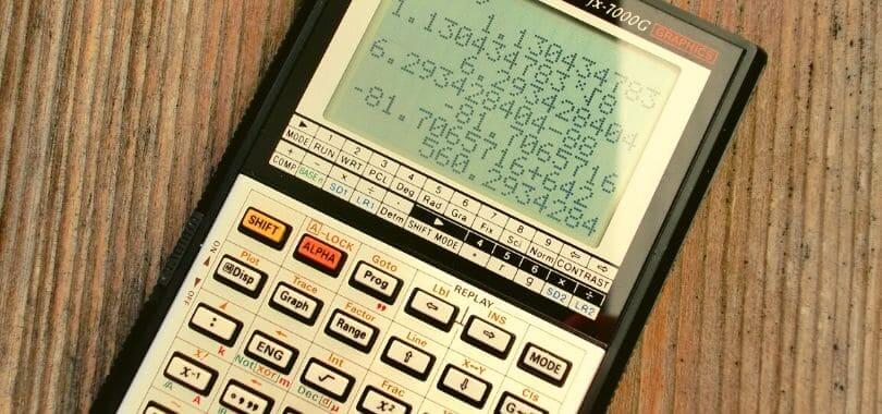 A black and white calculator with numbers on the screen.