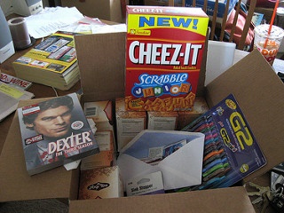 A box filled with school supplies and snacks.