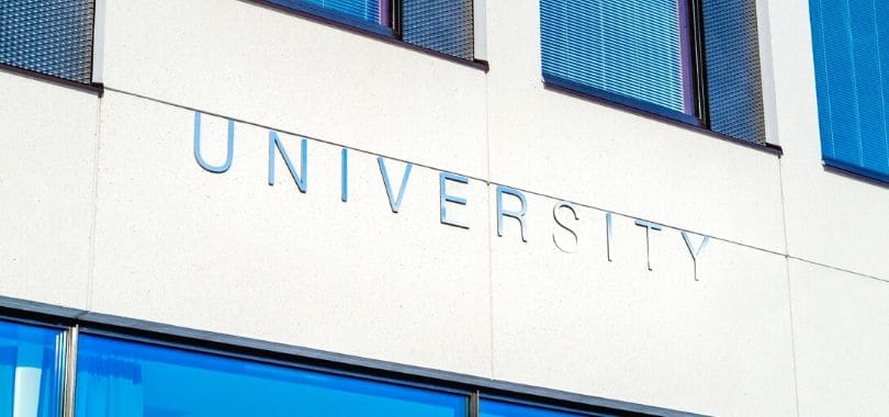 A "university" sign on the side of a building.