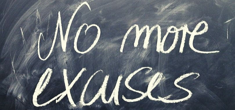 A chalkboard with writing that says "no more excuses."