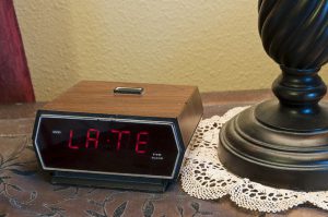 Digital alarm clock showing "late".