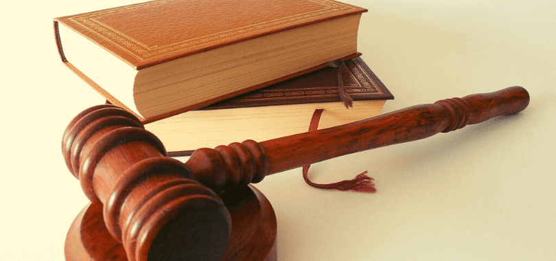 A gavel next to two stacked books.