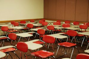 A Union College classroom with red chairs and white desks.