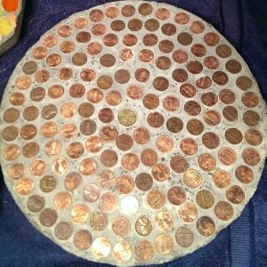 Bronze coins glued in a circular stone.