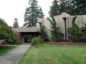 Ingram Hall at Pacific Lutheran University surrounded with green trees.