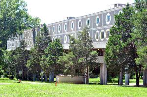 Tougaloo College campus building covered with green trees.