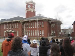 Washington State University students facing a school building.
