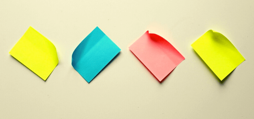 Four post-it notes stuck to a surface.