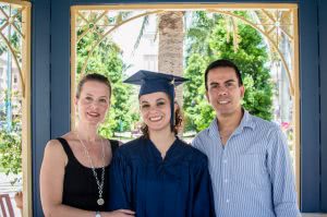 College graduate with her parents.