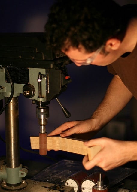 A man working on woodworking machine.