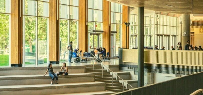 Students sitting in a university campus building.