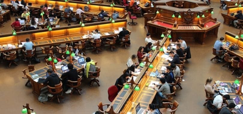 Students sitting in a college library.