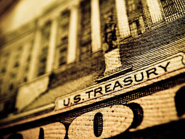 Dollar bill macro shot showing "US Treasury" print.