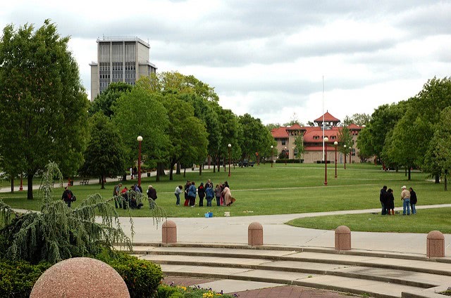 Students gathering in The Queens College campus field.