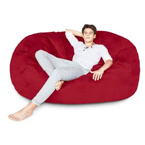 A student lying in a red Lumaland bean bag lounger. Click to view its Amazon page.