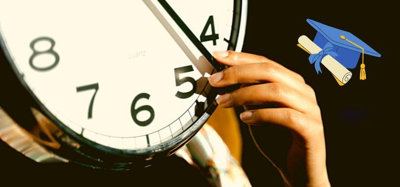 A student's hand reaches up to hold the minute-hand of a clock. They consider applying early decision for multiple schools.